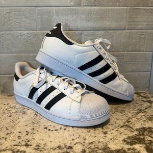 Black and white Adidas Superstars.